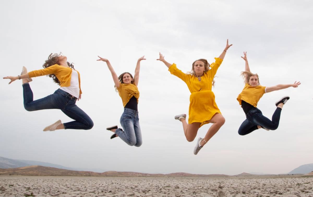 Four girls jumping in dance poses